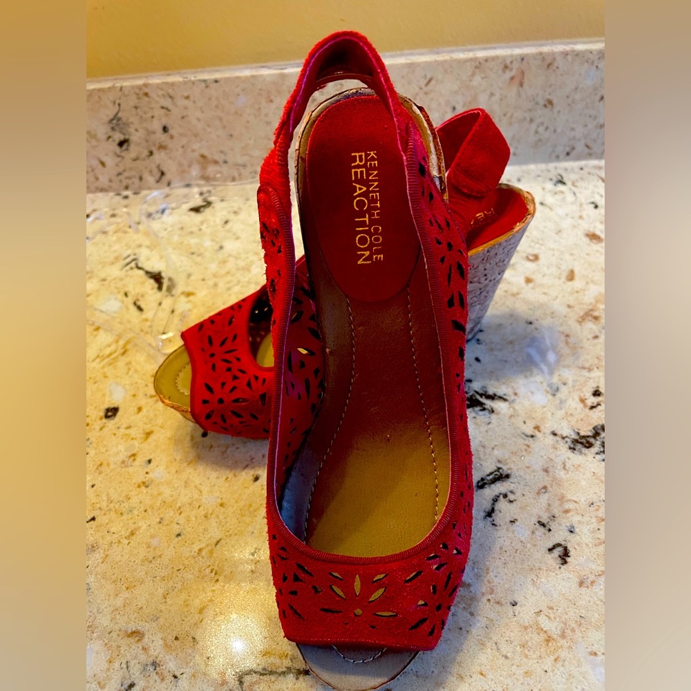 KENNETH COLE REACTS WITH RICH RED SUEDE FOR DRAMATIC EFFECT IN A PEEP TOE WEDGE